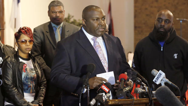 Attorney Daryl Parks, center, talks to reporters as Lesley McSpadden and Michael Brown Sr., right, parents of 18-year-old Michael Brown Jr., listen during a news conference March 5, 2015, in Dellwood, Mo. 