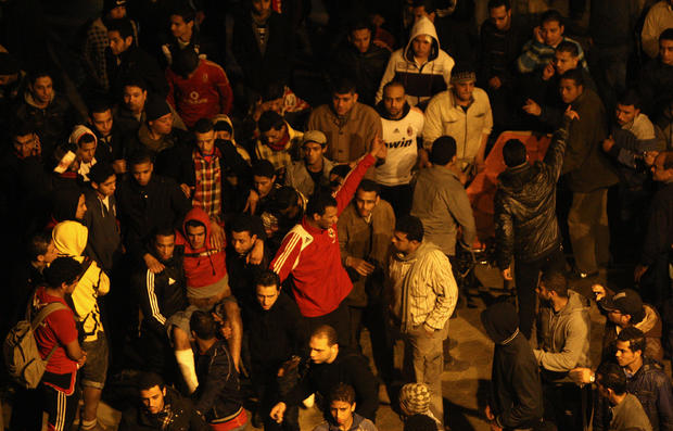 Egyptians carry a wounded Al-Ahly fan ou 