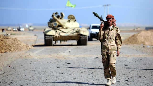 A Shiite fighter carries a rocket-propelled grenade launcher as he walks in the town of Hamrin in Salahuddin province 