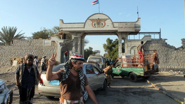 Armed Yemeni militiamen loyal to President Abed Rabbo Mansour Hadi gather at the entrance to the Yemeni special forces command in the southern city of Aden 