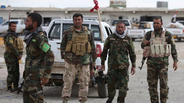 Iraqi Sunni fighters stand on Mar. 22, 2015 at a checkpoint at the entrance of Al-Alam, a flashpoint town north of Tikrit along the Tigris river, which has been fully under the control of pro-Iraqi government fighters and local Sunni tribesmen opposed to  
