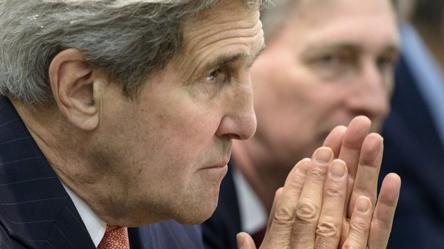 Secretary of State John Kerry waits with others before a meeting with P5+1, European Union and Iranian officials at the Beau Rivage Palace Hotel in Lausanne 