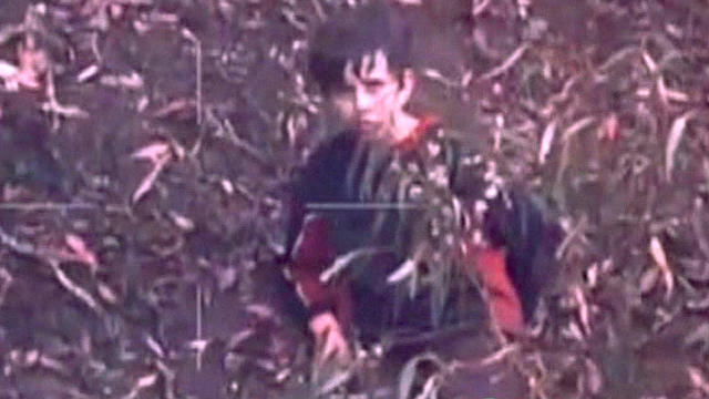 ​Luke Shambrook, 11, is seen in an Australian forest by a camera on board a police search helicopter 