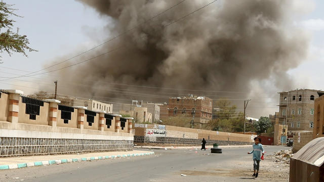 A girl runs for shelter during an airstrike in Sanaa 