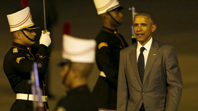 President Obama walks past an honor guard after arriving in Panama City 