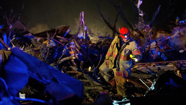 Crews search through wreckage on Illinois Highway 72 after a tornado came through Fairdale, Illinois, April 9, 2015. 