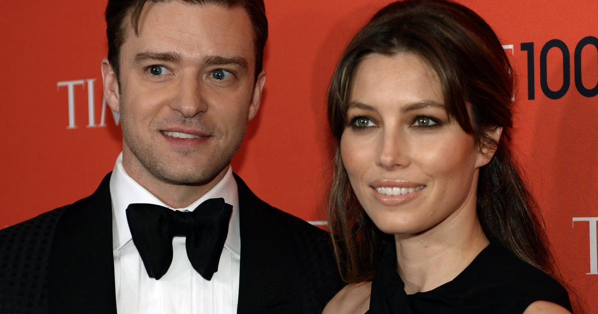 Justin Timberlake cradles son Silas as he and Jessica Biel board