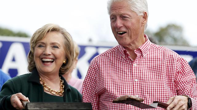 Hillary and Bill Clinton hold up steaks at 37th Harkin Steak Fry in Indianola, Iowa, in September 2014 file photo 