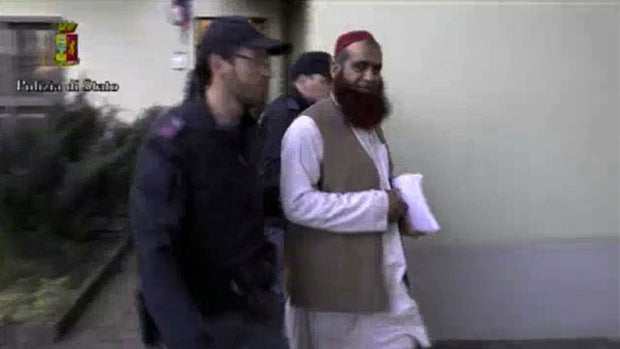 Italian policemen detain a man suspected to be a member of an armed organization inspired by al Qaeda in this still image taken from a video released by Italian Police April 24, 2015. 
