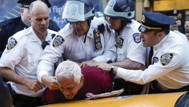 New York Police Department officers detain a protester during a march through the Manhattan borough of New York City calling for social, economic and racial justice, April 29, 2015. 