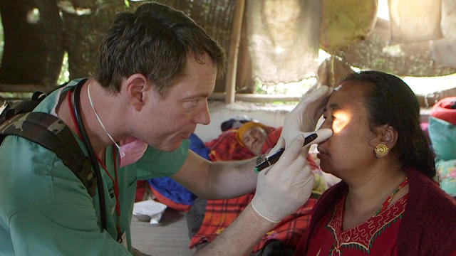 ​British physician Dr. Christopher Barley assesses the injuries of a woman injured in Nepal's devastating earthquake, in Sankhu, Nepal 