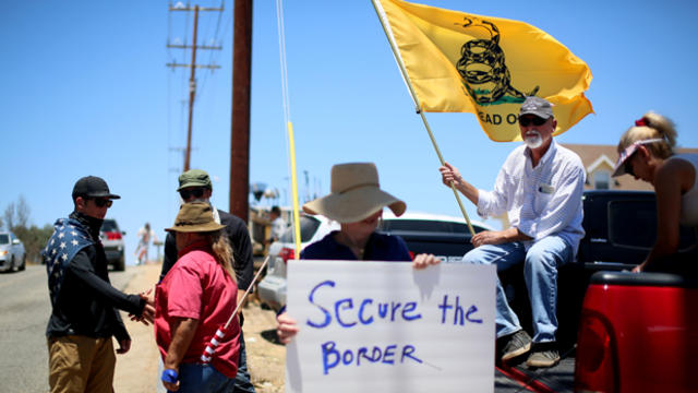 Anti-immigration activists protest outside of the U.S. Border Patrol Murrieta Station July 7, 2014, in Murrieta, California. 