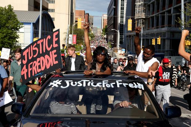 Protesters march on the street from City Hall a day after Baltimore authorities released a report on the death of Freddie Gray May 2, 2015, in Baltimore, Maryland. 
