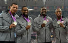 Ryan Bailey, Tyson Gay, Justin Gatlin and Trell Kimmons pose on the podium after winning the men's 4X100 relay final at the athletics event during the London 2012 Olympic Games Aug. 11, 2012, in London. 