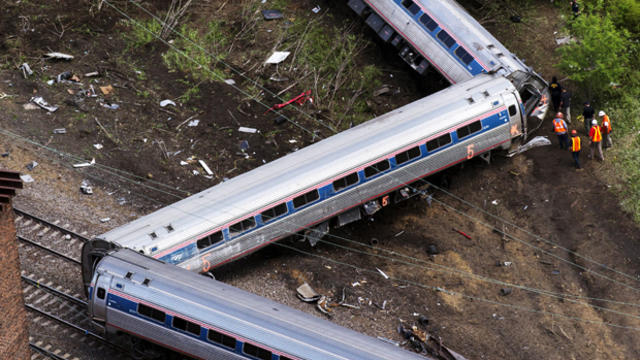 Emergency workers and Amtrak personnel inspect a derailed Amtrak train in Philadelphia, Pennsylvania, May 13, 2015. 