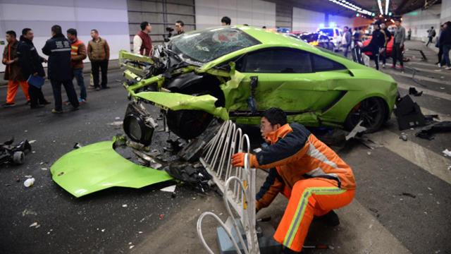 A badly damaged Lamborghini car and debris are seen in a tunnel after a crash involving a Ferrari in Beijing April 12, 2015. 