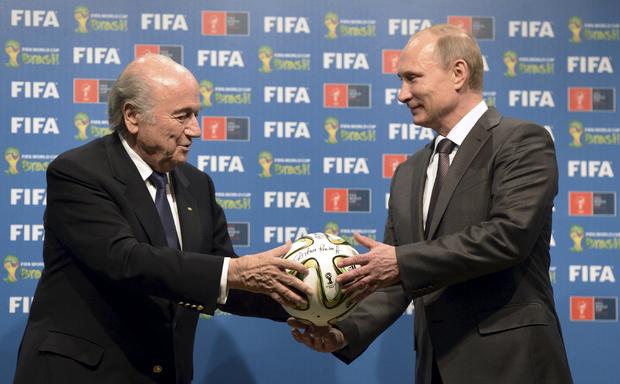 Russia's President Vladimir Putin and FIFA President Sepp Blatter take part in the official handover ceremony for the 2018 World Cup in Rio de Janeiro 