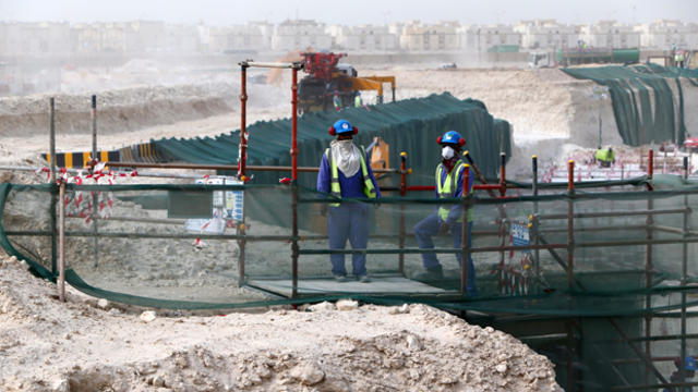 Foreign laborers work at the construction site of the al-Wakrah football stadium, one of the Qatar's 2022 World Cup stadiums, May 4, 2015, in Doha's Al-Wakrah southern suburbs. 