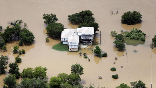 Floodwaters from the Brazos River encroach upon a home in the Horseshoe Bend neighborhood May 29, 2015, in Weatherford, Texas. 