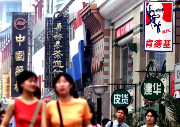Chinese shoppers walk through Beijing's main downt 