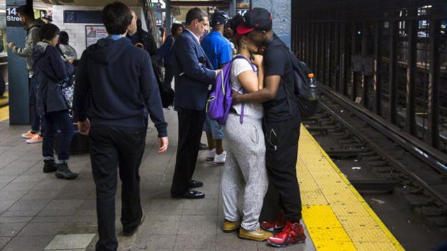 A couple embraces while waiting for the subway in New York June 1, 2015. 