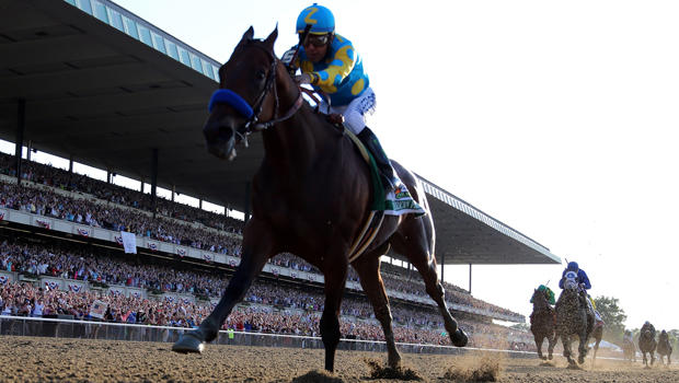 American Pharoah, No. 5, ridden by Victor Espinoza, comes down the final stretch ahead of the field on his way to winning the 147th running of the Belmont Stakes at Belmont Park June 6, 2015, in Elmont, New York. 