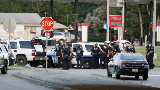 Police block the intersection of Dowdy Ferry Road and Interstate 45 during a standoff with a gunman barricaded inside a van June 13, 2015, in Hutchins, Texas. The gunman allegedly attacked Dallas Police headquarters. 