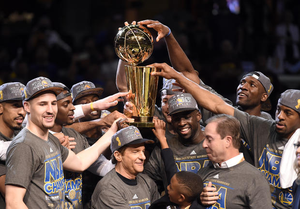 Golden State Warriors celebrate with Larry O'Brien Trophy after beating Cleveland Cavaliers in Game 6 of the NBA Finals at Quicken Loans Arena in Cleveland on June 16, 2015 