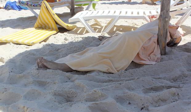 The body of an unidentified tourist shot dead by a gunman lies near a beachside hotel in Sousse 