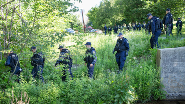 Law enforcement officers head into the woods as the manhunt for convicted murderers Richard Matt and David Sweat continues June 26, 2015, in Chasm Falls, New York. 