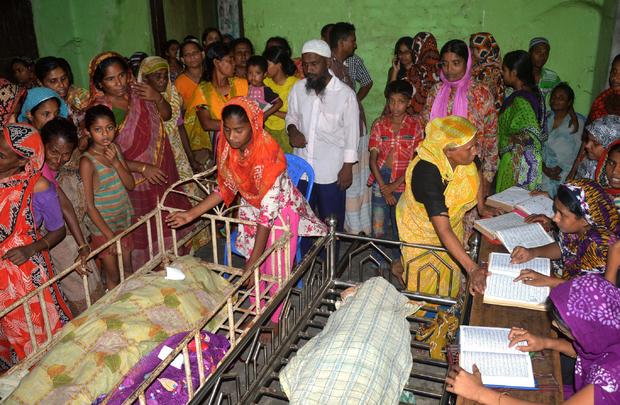 Bangladeshi relatives surround the bodies of some of those killed in a stampede at a charity distribution event in Mymensingh 
