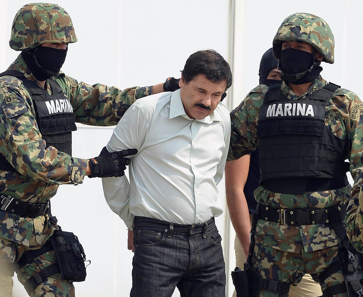 Mexican drug trafficker Joaquin Guzman Loera, also known as "El Chapo," is escorted by marines as he is presented to the press on Feb. 22, 2014, in Mexico City. 