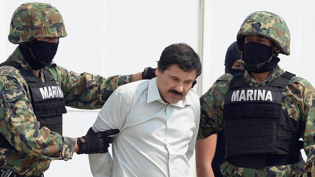 Mexican drug trafficker Joaquin Guzman Loera, also known as "El Chapo," is escorted by marines as he is presented to the press on Feb. 22, 2014, in Mexico City. 