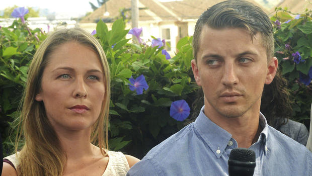 Denise Huskins and her boyfriend, Aaron Quinn, listen as their attorneys speak at a news conference July 13, 2015, in Vallejo, Calif. 