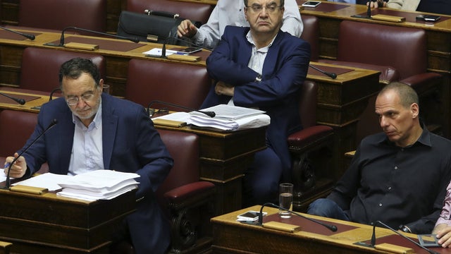 Greek Former Finance Minister Yanis Varoufakis (R), former Deputy Labor Minister Dimitris Stratoulis (C) and former Energy Minister Panagiotis Lafazanis attend a parliamentary session in Athens, Greece 