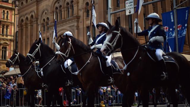 Australian police officers on horseback take part in the Anzac Day parade along George Street in Sydney 