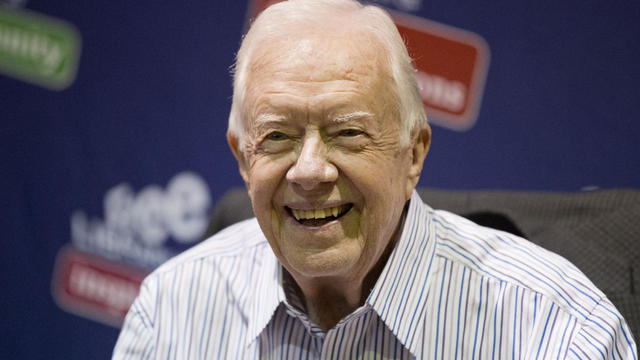 Former President Jimmy Carter poses for photographs at an event for his new book "A Full Life: Reflections at Ninety" at the Free Library in Philadelphia July 10, 2015. 