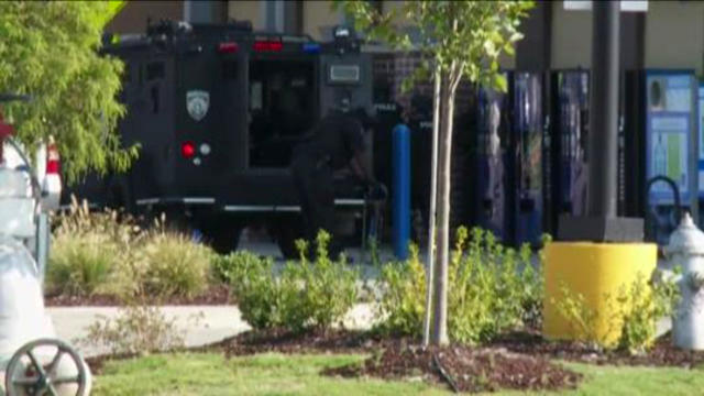 ​New Orleans Police Department officers work the scene after a report of an armed robbery at a Walmart Aug. 15, 2015. 