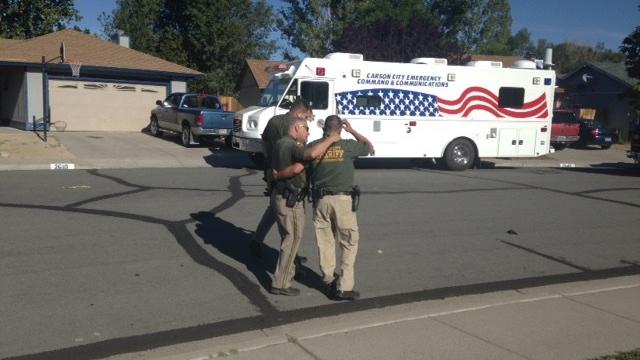 Carson City sheriff's deputies comfort each other after a fellow deputy was shot and killed by a domestic violence suspect Aug. 15, 2015, in Carson City, Nevada. 