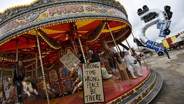 People ride a carousel at "Dismaland," a theme park-styled art installation by British artist Banksy at Weston-super-Mare in southwest England, Britain, Aug. 20, 2015. 