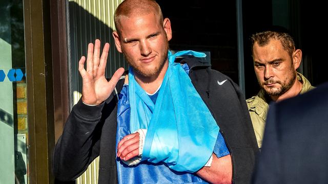 Off-duty U.S. Air Force Airman Spencer Stone, left, one of the men to overpower the gunman who opened fire with an assault rifle on a high-speed train, gestures as he leaves the hospital in Lesquin, northern France, Aug. 22, 2015. 