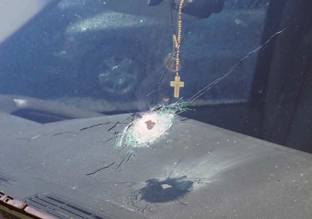 This undated photo released by the Arizona Department of Public Safety shows a bullet hole in the windshield of a vehicle in Phoenix. 