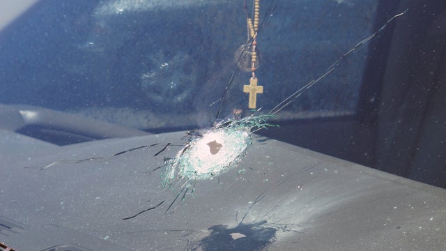 This undated photo released by the Arizona Department of Public Safety shows a bullet hole in the windshield of a vehicle in Phoenix. 