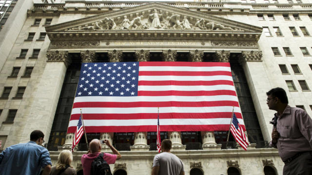 A large U.S. flag hangs on the facade of the New York Stock Exchange in New York Sept. 3, 2015. 