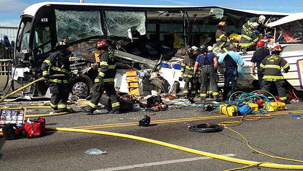 Firefighters assist victims after a crash between a bus and a tour vehicle on the Aurora Avenue bridge in Seattle, Washington, in this picture from the Seattle Fire Department Sept. 24, 2015. 