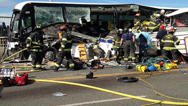 Firefighters assist victims after a crash between a bus and a tour vehicle on the Aurora Avenue bridge in Seattle, Washington, in this picture from the Seattle Fire Department Sept. 24, 2015. 