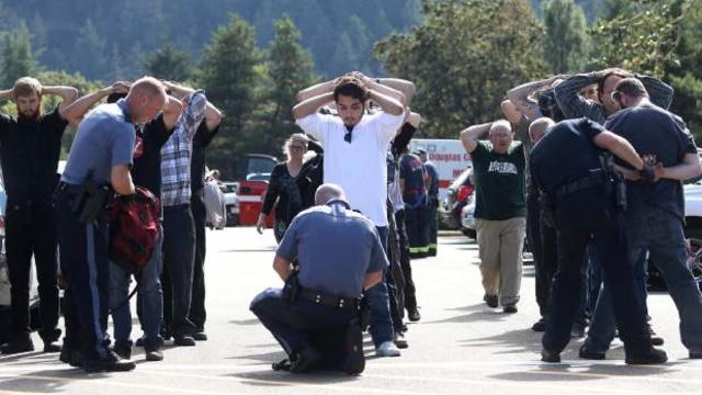 Authorities check bags as students and staff are moved off campus at Umpqua Community College after a shooting Oct. 1, 2015. 