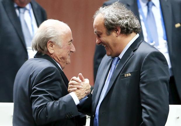 UEFA President Michel Platini (R) congratulates FIFA President Sepp Blatter after he was re-elected at the 65th FIFA Congress in Zurich, Switzerland, in this file picture 