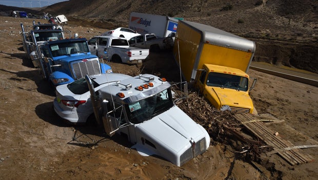 Vehicles are stuck on a road after being trapped by a mudslide on California Highway 58 in Mojave, California, Oct. 16, 2015, after torrential rains swamped the area and forced drivers and passengers to flee on foot.