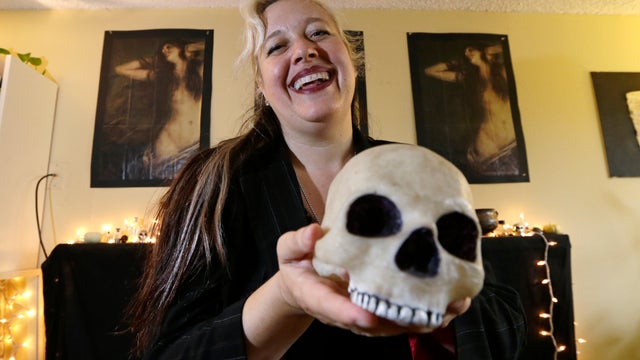 Lilith Starr, chapter head of The Satanic Temple of Seattle, holds a plastic skull while being photographed in her home Oct. 28, 2015, in Seattle. 